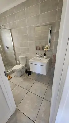 a bathroom with a toilet and a sink at Luxury Apartment in Somerset West in Strand