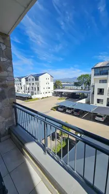 a balcony with a view of a parking lot at Luxury Apartment in Somerset West in Strand