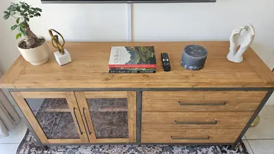 a wooden table with books on top of it at Luxury Apartment in Somerset West in Strand