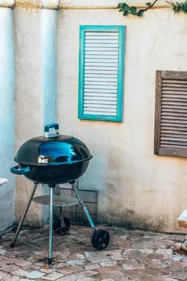 a black bbq grill in front of a building at Amulet At The Sea in Hermanus