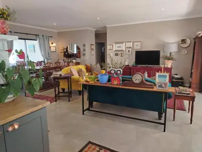 a living room with a couch and a table at Columbus Whales in Hermanus