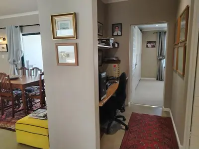 a home office with a desk and a dining room at Columbus Whales in Hermanus