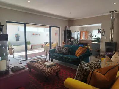 a living room with a couch and a table at Columbus Whales in Hermanus