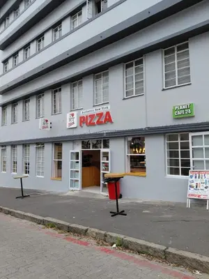 a pizza store on the side of a building at Granaat Pit - Paarl - Self Catering Apartment in Paarl