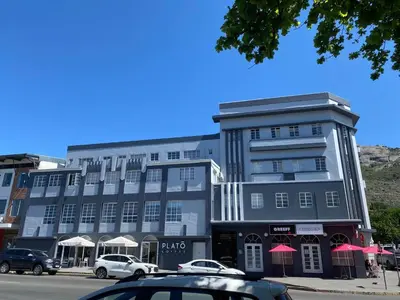 a large building with cars parked in front of it at Granaat Pit - Paarl - Self Catering Apartment in Paarl