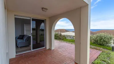 an open patio with a couch on a patio at 258 Hermanus Beach club in Hermanus