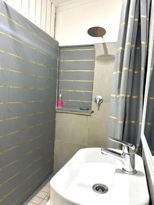 a bathroom with a sink and a shower at Private Flatlet B in Goodwood