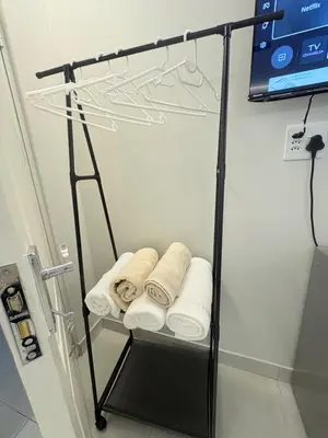a towel rack in a bathroom with towels at Ocean Whisper Room 6 minutes away from the beach in Cape Town