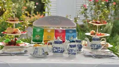a table with blue and white cups and plates of food at Le Franschhoek Hotel & Spa by Dream Resorts in Franschhoek
