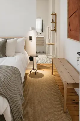 a bedroom with a bed and a wooden table at Dorpshuis Apartment, Main Street, Paarl in Paarl