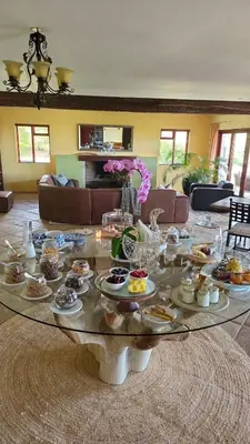 a living room with a table with food on it at Apricot Gardens Guesthouse in Gordonʼs Bay