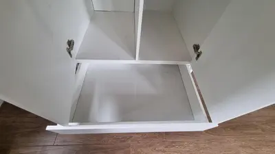 a white cabinet with glass doors on top of a wooden floor at Stellebosch garden flat in Stellenbosch