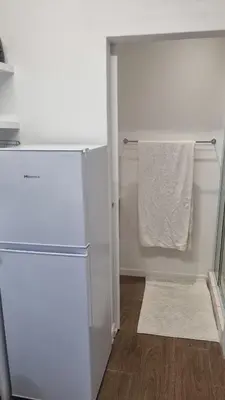 a white refrigerator in a kitchen with a towel at Stellebosch garden flat in Stellenbosch