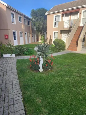 a plant in a yard next to a building at 46 Atlanta - A Home away from Home in Strand