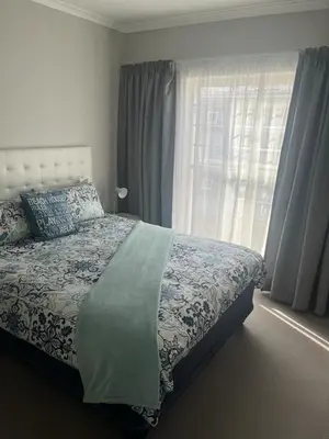 a bedroom with a bed and a window at 46 Atlanta - A Home away from Home in Strand