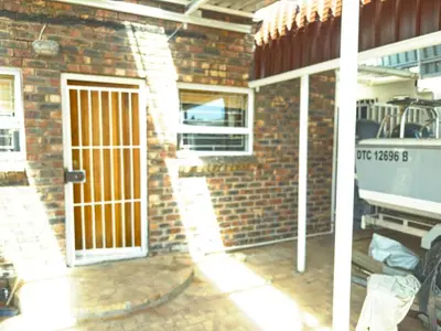 a brick building with a door with a gate at 2 Elwyn Road