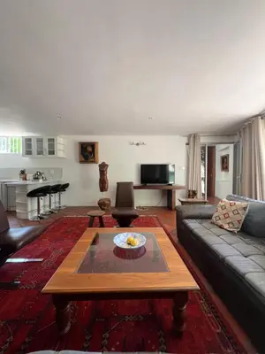 a living room with a couch and a table at Spacious Self-Catering Apartment with Private Entrance in Peaceful Paradyskloof, Stellenbosch in Stellenbosch