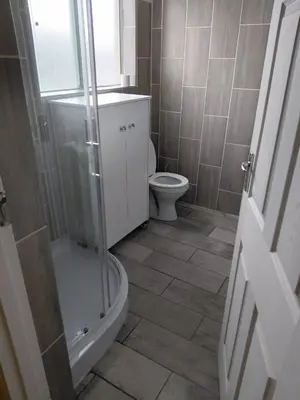 a bathroom with a toilet and a glass shower at Unit 8 Hermanus Beach Club in Hermanus