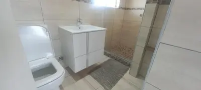 a bathroom with a toilet and a sink and a shower at Unit 169 Hermanus Beach Club in Hermanus