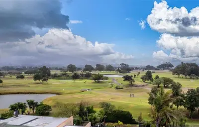 a view of a golf course with a pond at Greens Golf Course Apartment in De Grendel