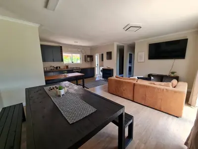 a living room with a couch and a table at Kuku House in Cape Town