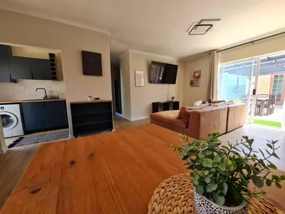 a living room with a couch and a table at Kuku House in Cape Town