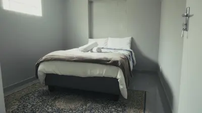a bedroom with a bed with a teddy bear on it at Halaal Serenity 3bedroom 6sleeper in Cape Town