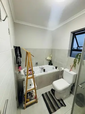 a bathroom with a toilet and a bath tub at Tranquil Luxe Retreat in Cape Town