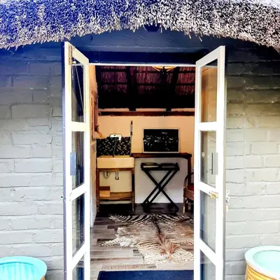 an open door to a room with a table at Bobbejaanskloof in Bettyʼs Bay