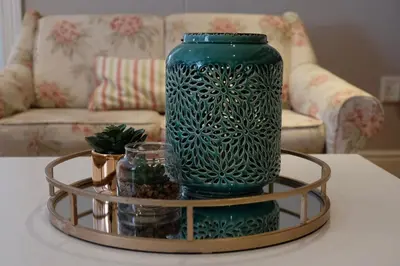 a green vase sitting on top of a coffee table at Sipres Garden in Durbanville