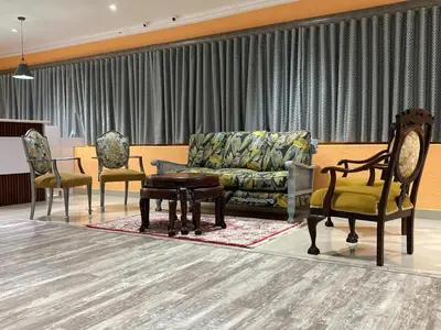 a living room with a couch and two chairs at Pro Max Guesthouse Goodwood in Goodwood