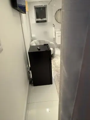 a small room with a chair and a toilet at Cherrywood Guest House in Cape Town