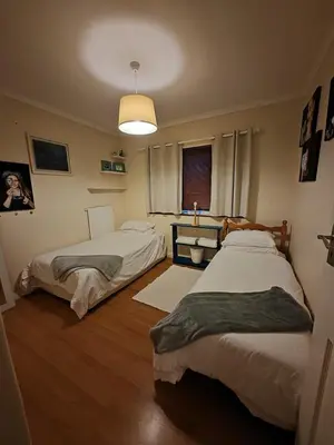 a bedroom with two beds and a window at The Palm's on Pastorie in Pniel