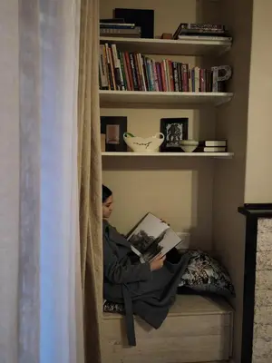 a person reading a book in a book shelf at The Palm's on Pastorie in Pniel