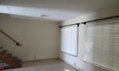 a room with a window with blinds and a staircase at p22 voevlei in Victory Hill