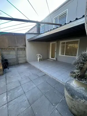 a patio outside of a house with a chair at p22 voevlei in Victory Hill