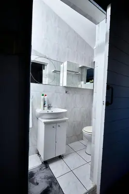 a bathroom with a sink and a toilet at Townhouse in Bloubergstrand in Cape Town