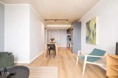 a living room with a table and chairs at 510 Riverlands - Lux 1 bedroom Apartment in Cape Town
