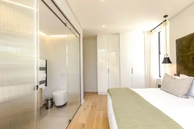 a bedroom with a bed and a glass wall at Stylish Apartment in Cape Winelands District in Stellenbosch
