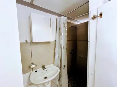a small bathroom with a sink and a shower at White Pearl at Strand in Strand