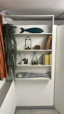 a book shelf with a blue fish on it at White Pearl at Strand in Strand