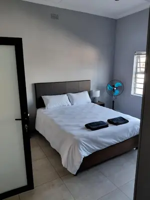 a bedroom with a bed with two towels on it at Rihla Residences - Hanbury Road in Cape Town