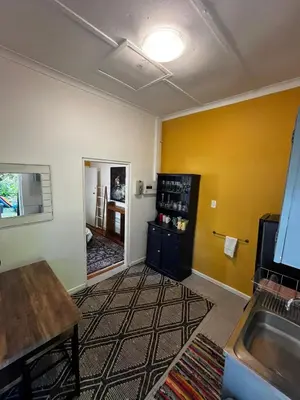 a room with a kitchen with a sink and a counter at Central Eclectic Studio by ARPA Hospitalities in Stellenbosch