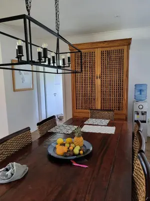 a bowl of fruit on a plate on a wooden table at Garden Pool Manor House in Kuilsrivier