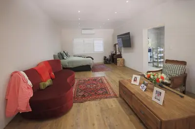 a living room with a couch and a table at Garden Pool Manor House in Kuilsrivier