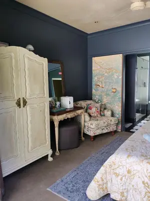 a bedroom with a white dresser and a mirror at Franschhoek Guest Suite in Franschhoek