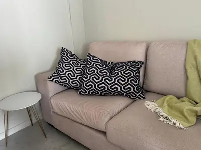 a couch with two pillows on it in a room at De Eike in Stellenbosch