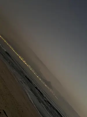 a view of the ocean from the beach at night at Blouberg Beach Gem 5 Min Walk in Cape Town