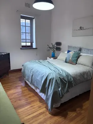 a white bedroom with a large bed in it at Catlovers Corner in Paarl