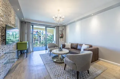 a living room with a couch and a table and chairs at Portifino on lake 221 The Island Club in Cape Town